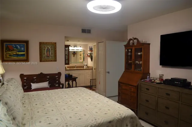 a bedroom with a bed and flat screen tv