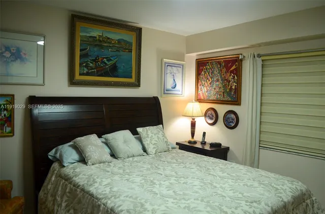 a bedroom with a bed and wall painting