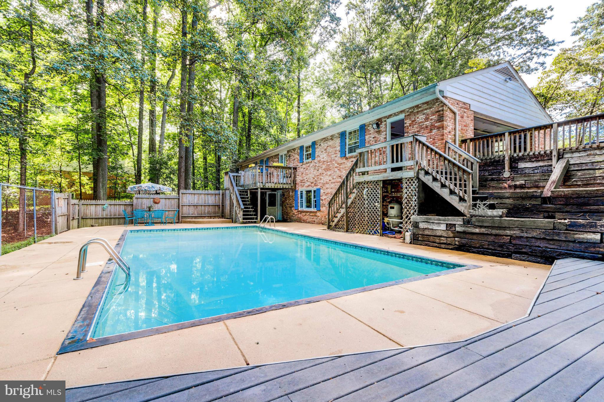 41377 Red Hill Road Leesburg, VA 20175 - Photo 22 of 24 Inground pool with concrete patio and raised deck