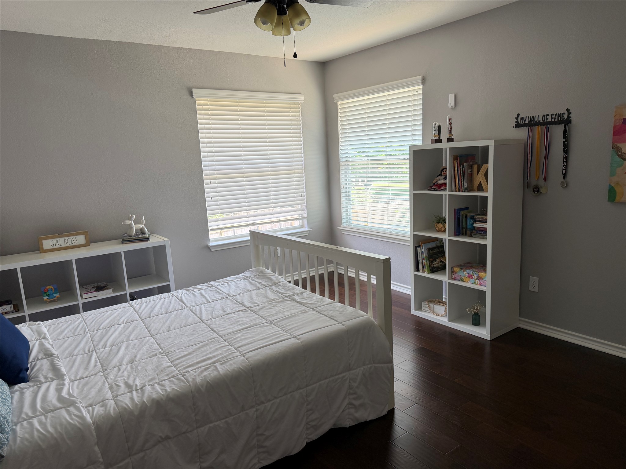 13 Oak View Round Rock, TX 78664 - Photo 19 of 30 Well-lit sleeping quarters with rich hardwood flooring and practical window treatments for ultimate comfort.