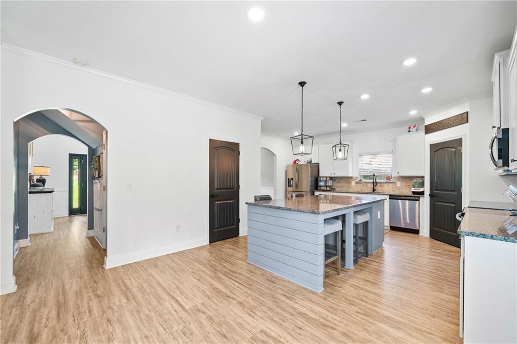 13 Four Feathers Lane Northeast Rydal, GA 30171 - Photo 24 of 51 a kitchen with kitchen island wooden floor center island and stainless steel appliances