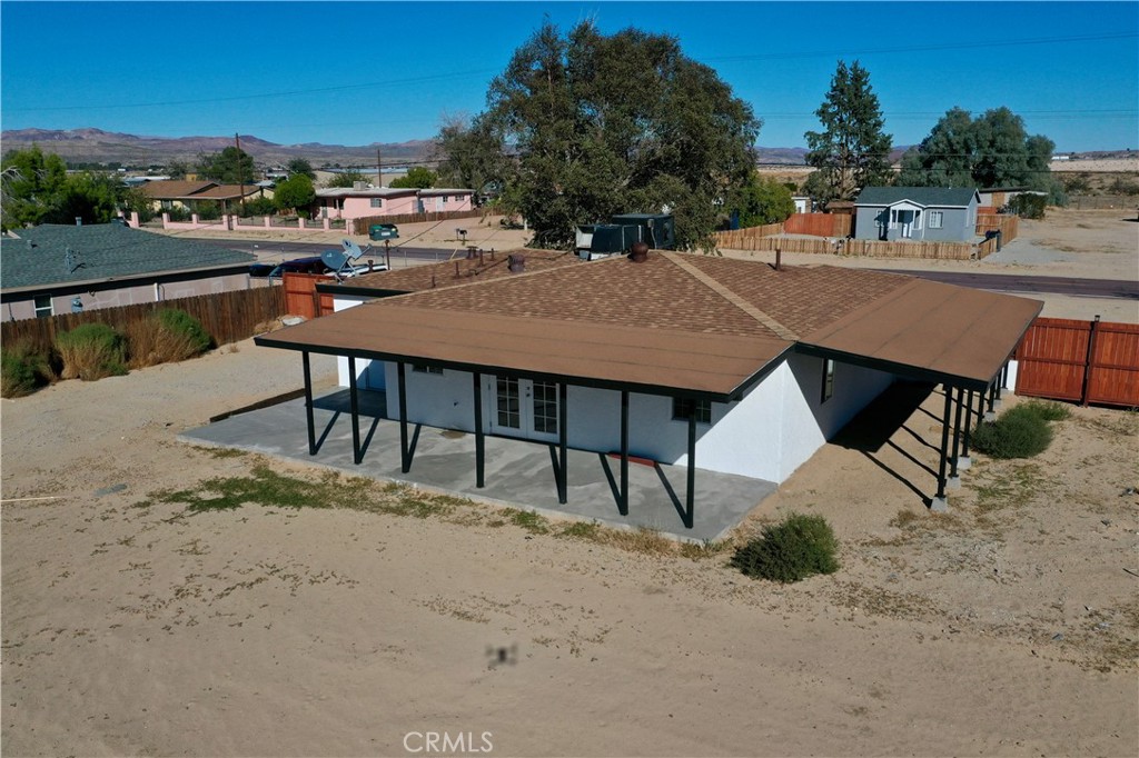 35010 Cedar Road Barstow, CA 92311 - Photo 14 of 14 a view of a patio with a table and chairs under an umbrella
