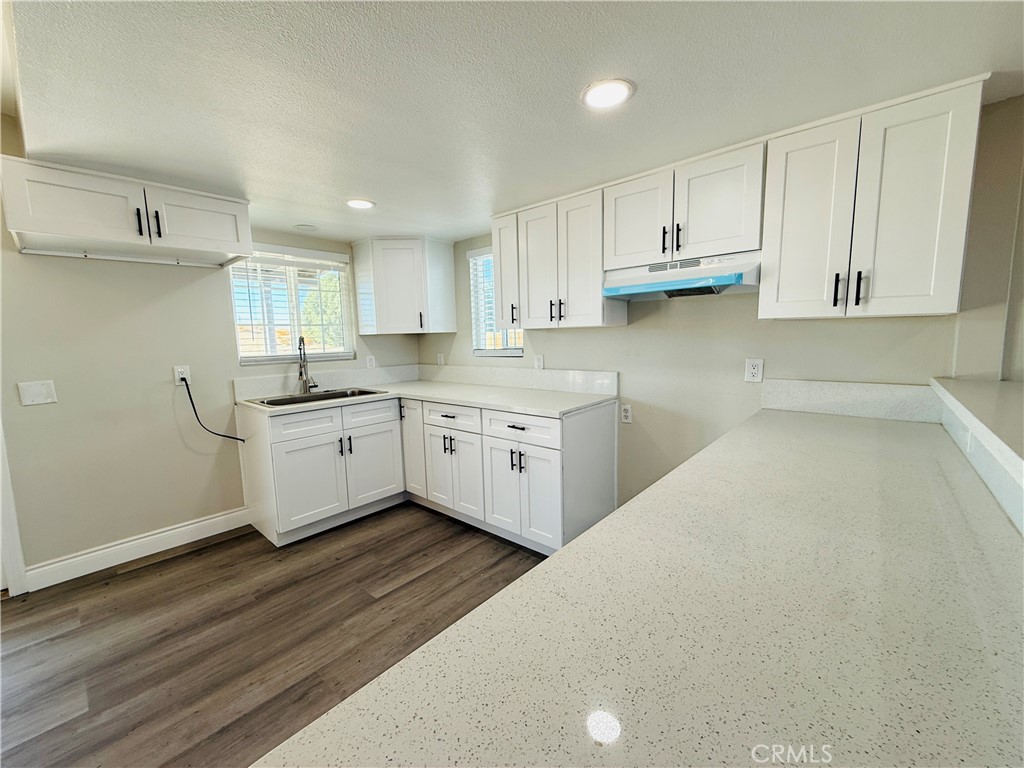 35010 Cedar Road Barstow, CA 92311 - Photo 4 of 14 a kitchen with stainless steel appliances a sink a stove a refrigerator and cabinets