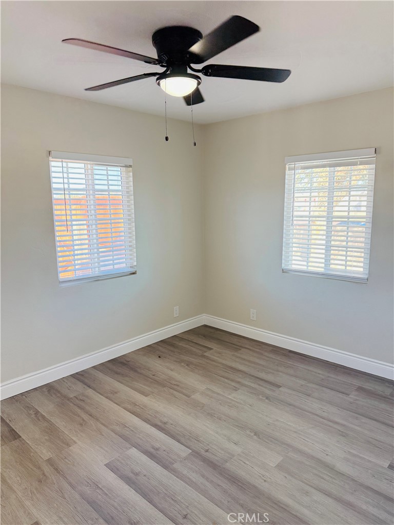 35010 Cedar Road Barstow, CA 92311 - Photo 8 of 14 a view of an empty room with wooden floor and a window