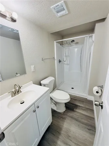a bathroom with a toilet sink and shower