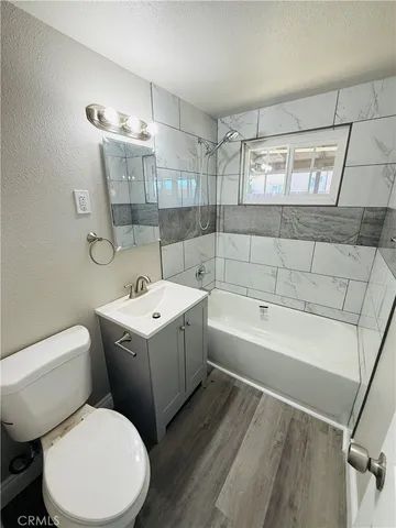 a white toilet sitting next to a bathroom sink