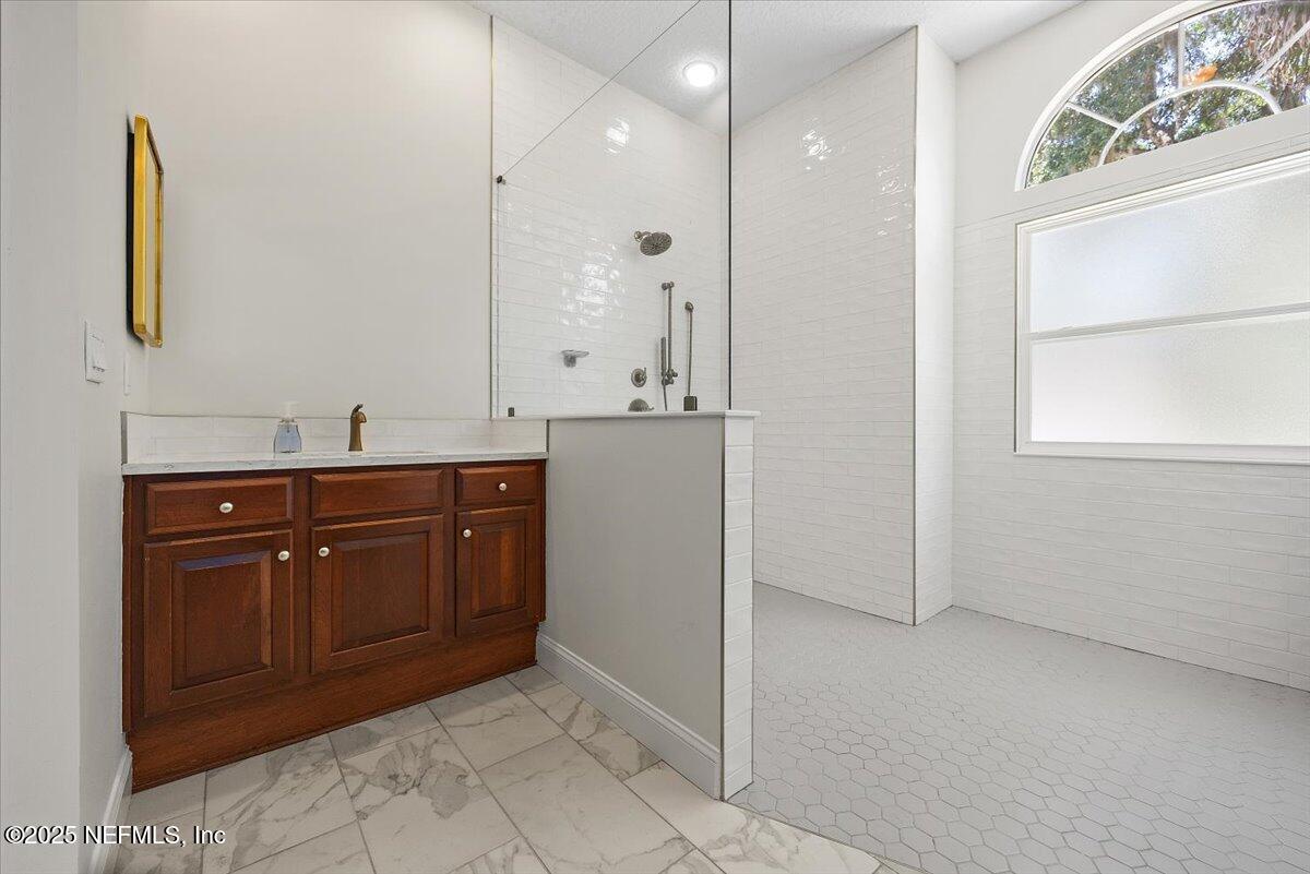 840 Mill Stream Road Ponte Vedra Beach, FL 32082 - Photo 15 of 29 a bathroom with a granite countertop sink a mirror and a vanity