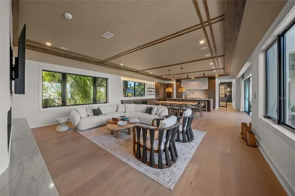 a living room with lots of furniture and a large window