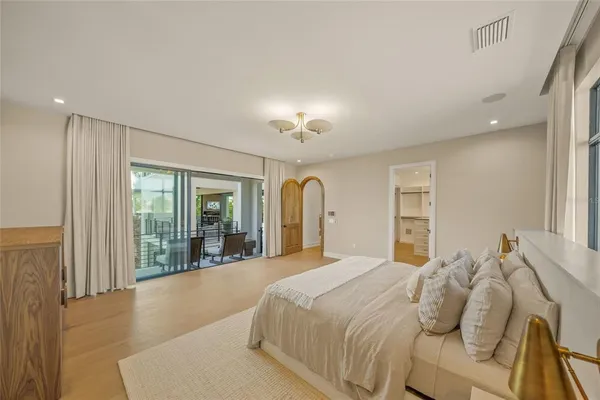 a bedroom with a large bed and a large window