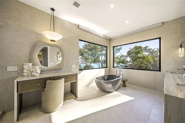 a large kitchen with kitchen island a large window in it