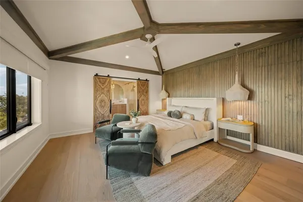 a bathroom with a white tub a sink and mirror