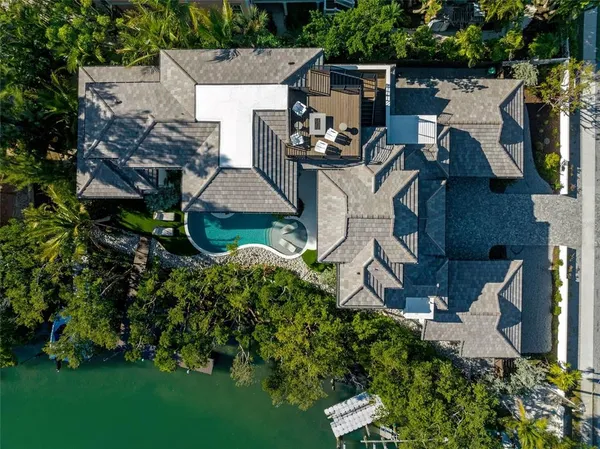 an aerial view of a house with garden space and street view