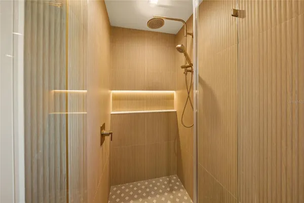 a bedroom with a bed mirror and window