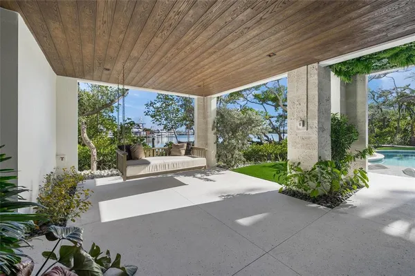 a view of a patio with table and chairs potted plants with wooden floor