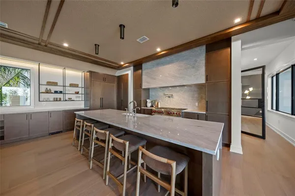 a kitchen with granite countertop a table chairs sink and wooden floor