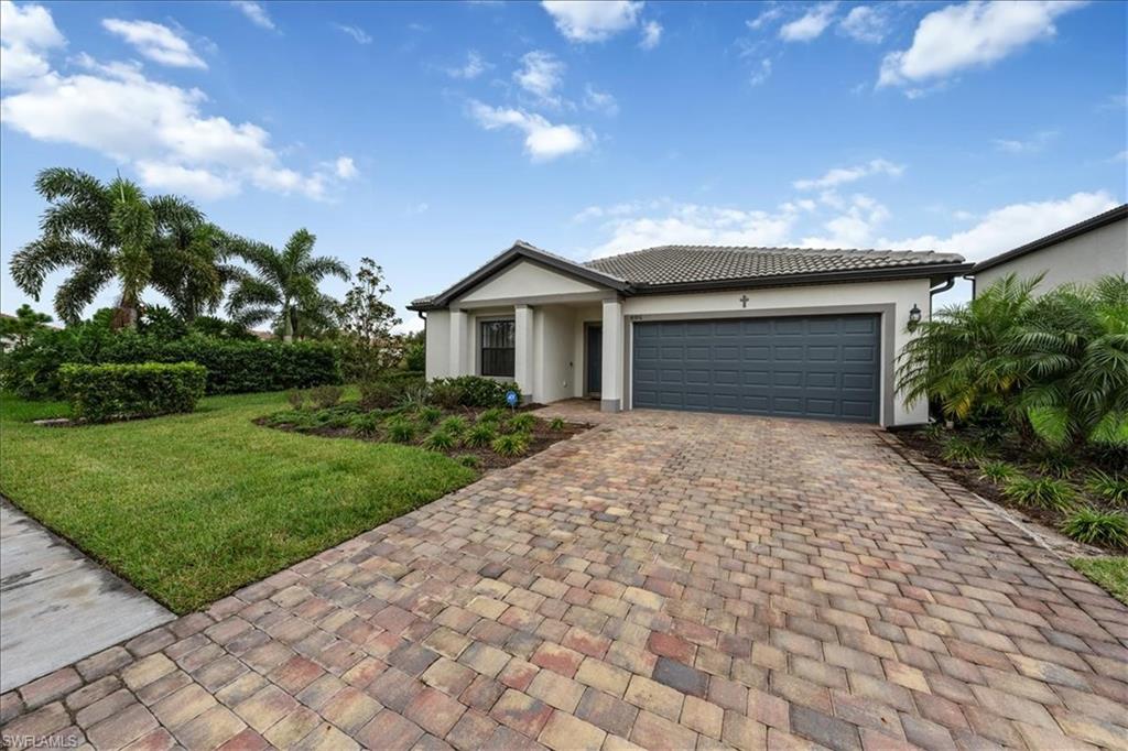 4596 Lamaida Lane Immokalee, FL 34142 - Photo 1 of 22 a front view of a house with a garden