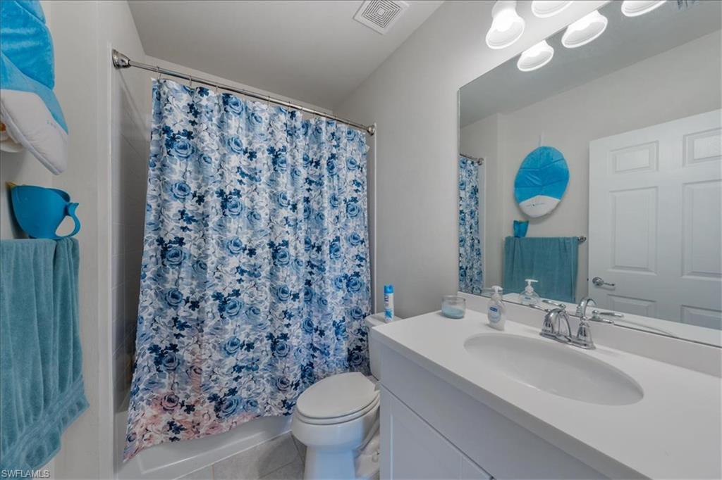 4596 Lamaida Lane Immokalee, FL 34142 - Photo 13 of 22 a bathroom with a sink toilet and a mirror