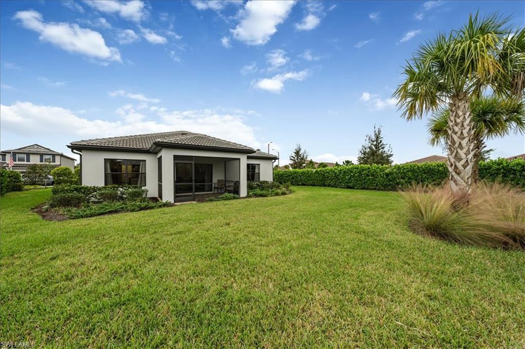4596 Lamaida Lane Immokalee, FL 34142 - Photo 19 of 22 a front view of a house with garden