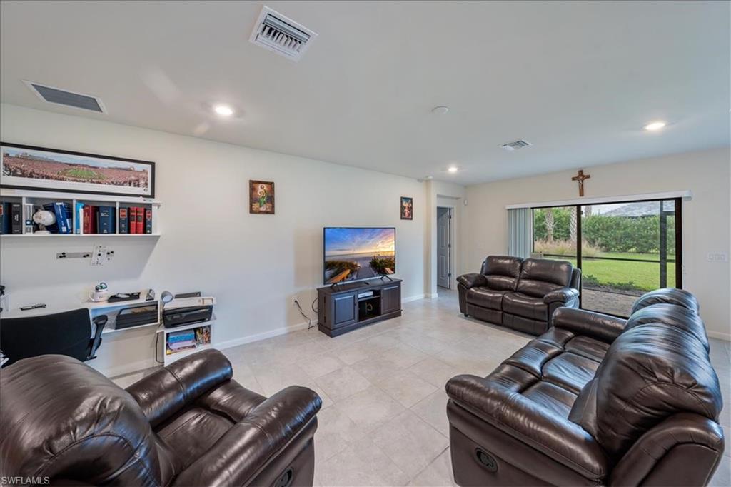 4596 Lamaida Lane Immokalee, FL 34142 - Photo 5 of 22 a living room with furniture a flat screen tv and a large window
