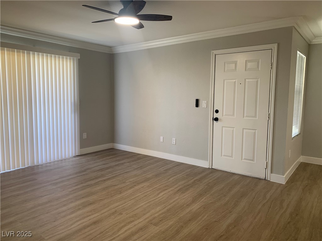 8101 West Flamingo Road, Unit 1102 Las Vegas, NV 89147 - Photo 11 of 54 Living room with ceiling fan, crown molding, wood finished floors, and plenty of natural light