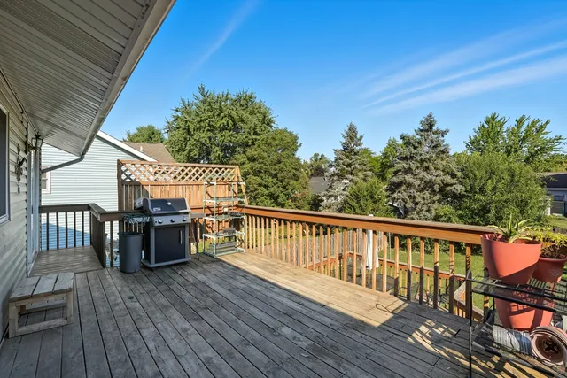 a view of balcony with wooden floor and seating space