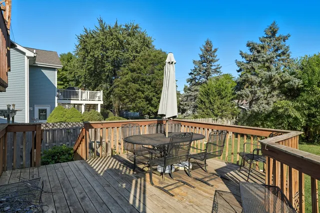 a view of a deck with two chair and wooden floor