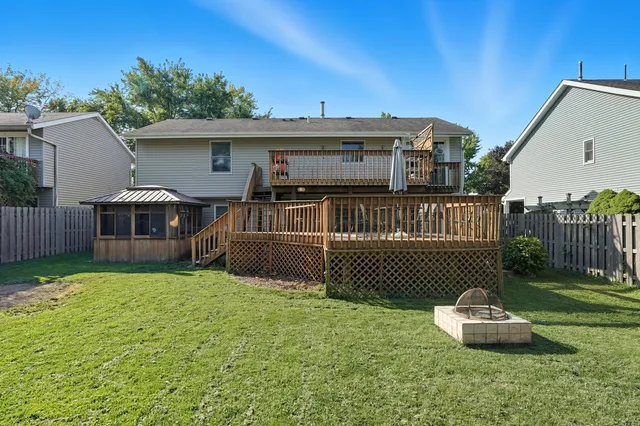 a front view of a house with a garden and deck