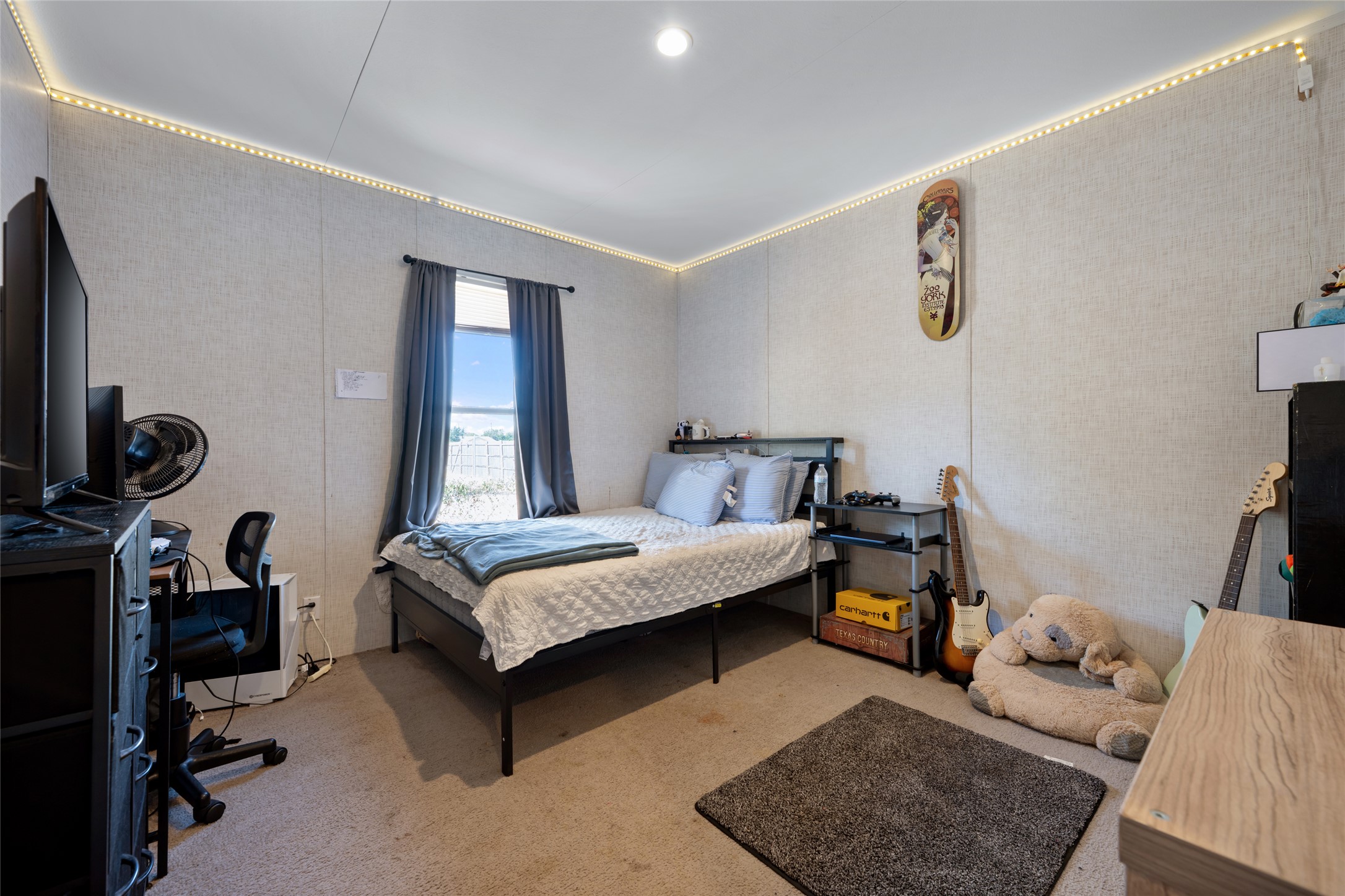 113 Sunflower Road Dale, TX 78616 - Photo 19 of 33 A tall window draws natural light into this cozy bedroom featuring soft carpet flooring.