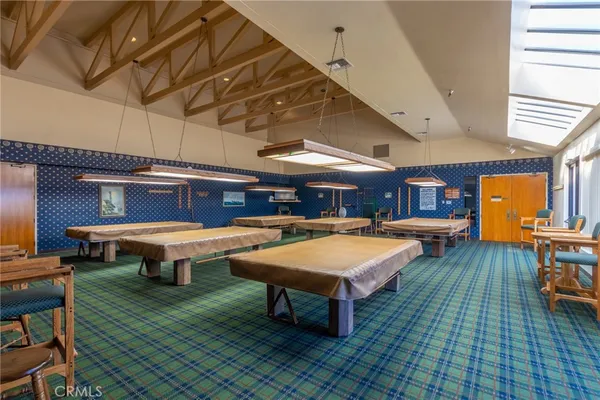 a room with pool table table and chairs