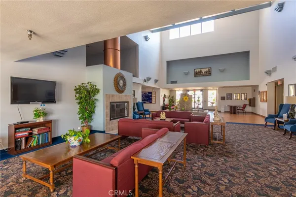 a living room with fireplace furniture and a flat screen tv