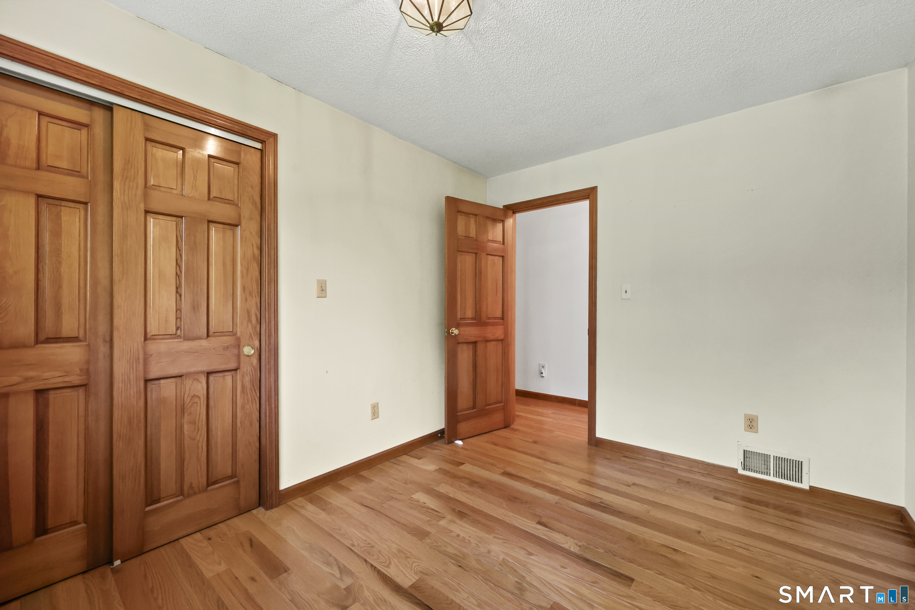 419 Birge Park Road Harwinton, CT 06791 - Photo 12 of 36 a view of an empty room with wooden floor