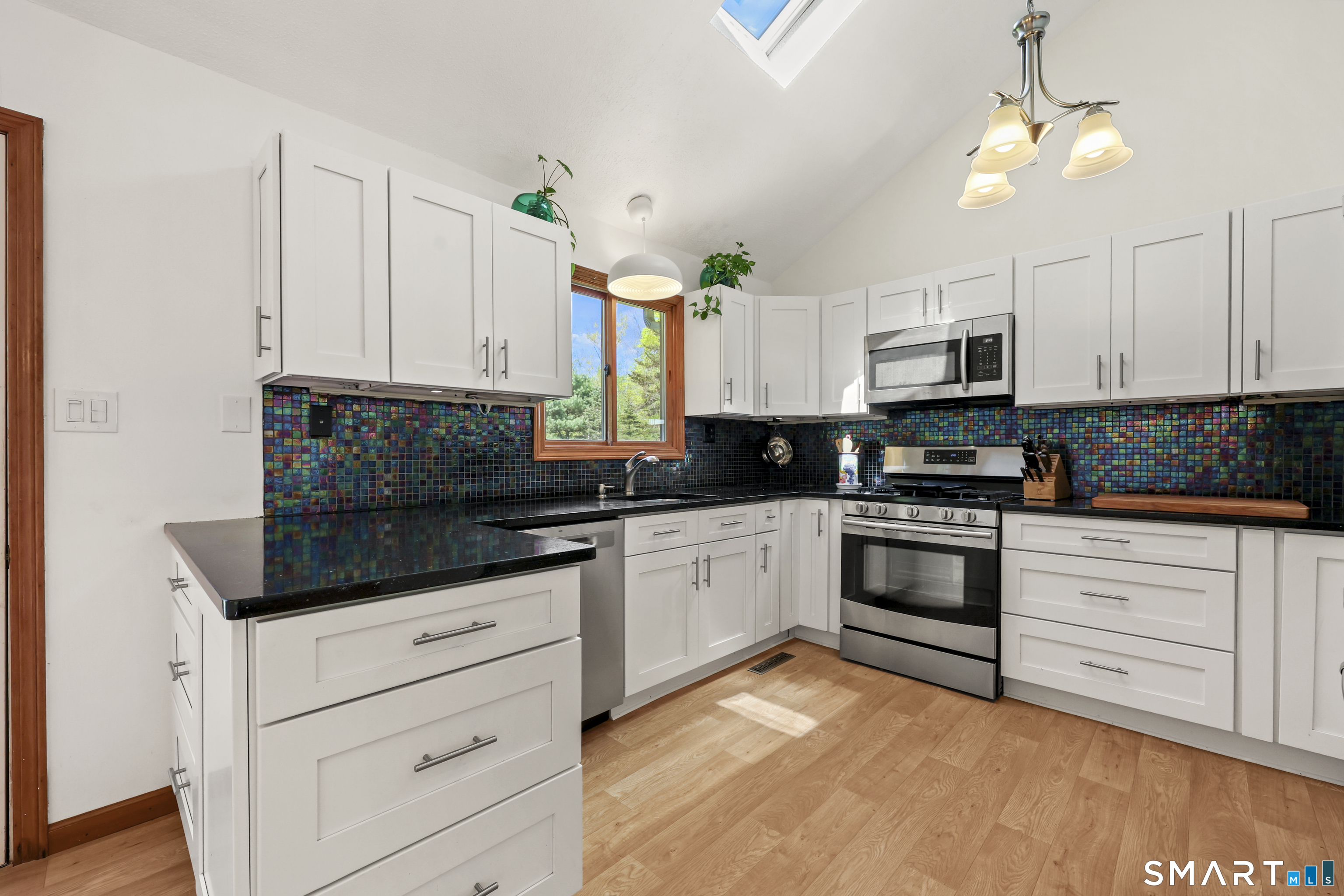 419 Birge Park Road Harwinton, CT 06791 - Photo 4 of 36 a kitchen with stainless steel appliances granite countertop white cabinets a sink a stove a dining table and chairs