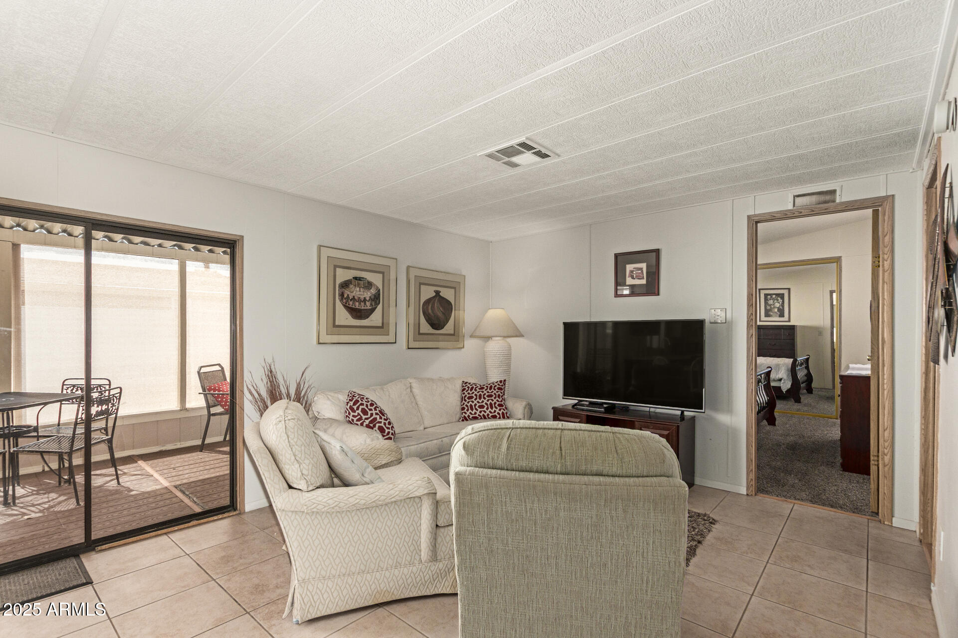 301 South Signal Butte Road, Unit 706 Apache Junction, AZ 85120 - Photo 17 of 51 a living room with furniture and a flat screen tv