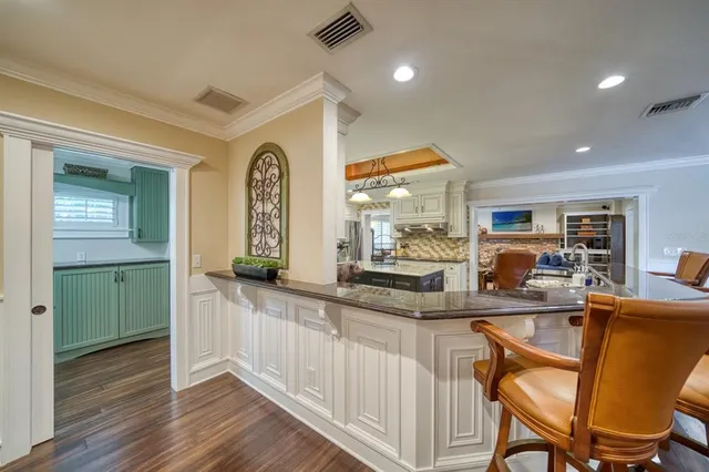 a kitchen with stainless steel appliances granite countertop a sink and cabinets