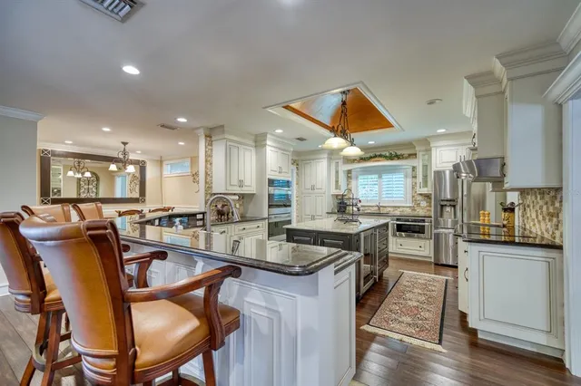 a kitchen with granite countertop lots of counter top space and stainless steel appliances