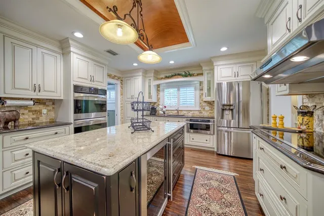 a kitchen with granite countertop stainless steel appliances and wooden cabinets