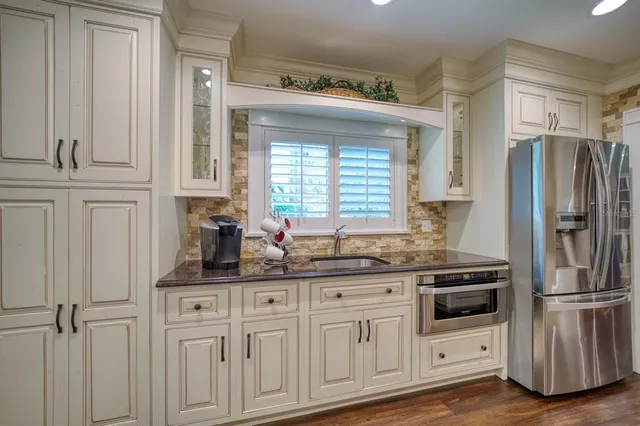 a kitchen with appliances cabinets and a window