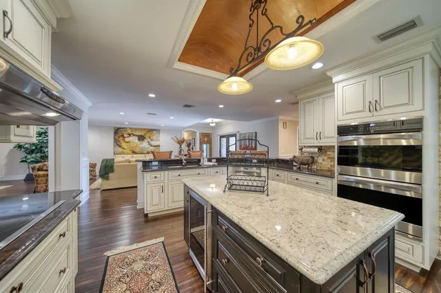 a kitchen with a stove center island and cabinets