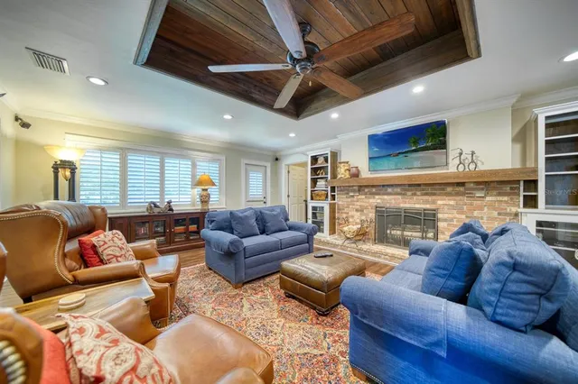 a living room with furniture ceiling fan and a fireplace