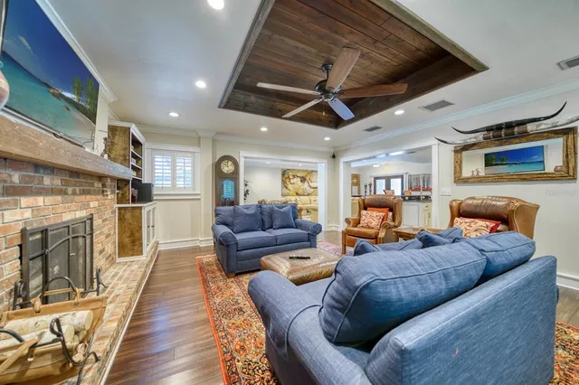a living room with fireplace furniture and a wooden floor