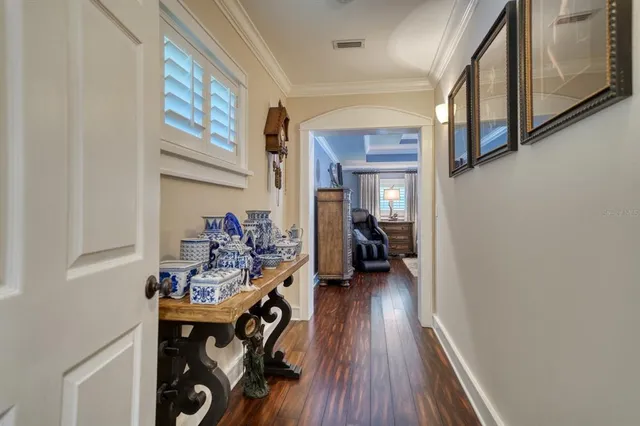 a view of a hallway with furniture and wooden floor