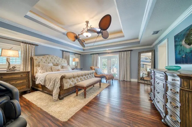 a bedroom with a bed wooden floor and window