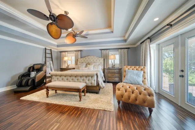 a bedroom with furniture and wooden floor