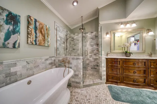 a bathroom with a tub a sink and a shower