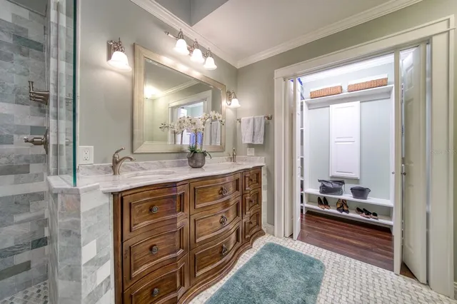 a spacious bathroom with a granite countertop sink a mirror and a shower