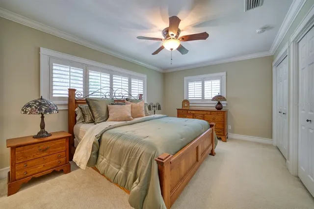 a bed room with a bed and a chandelier