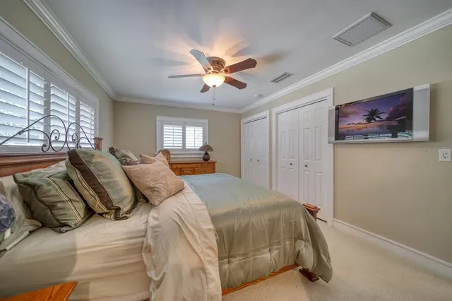 a bedroom with a large bed and a chandelier