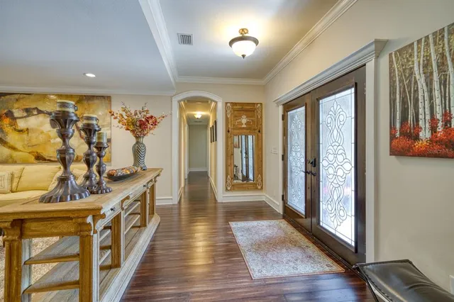 a hallway with furniture and wooden floor