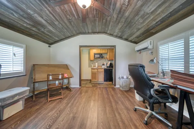 a dining room with furniture and wooden floor