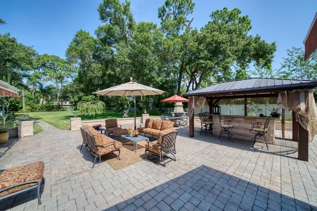 an outdoor space with patio lots of furniture and umbrella